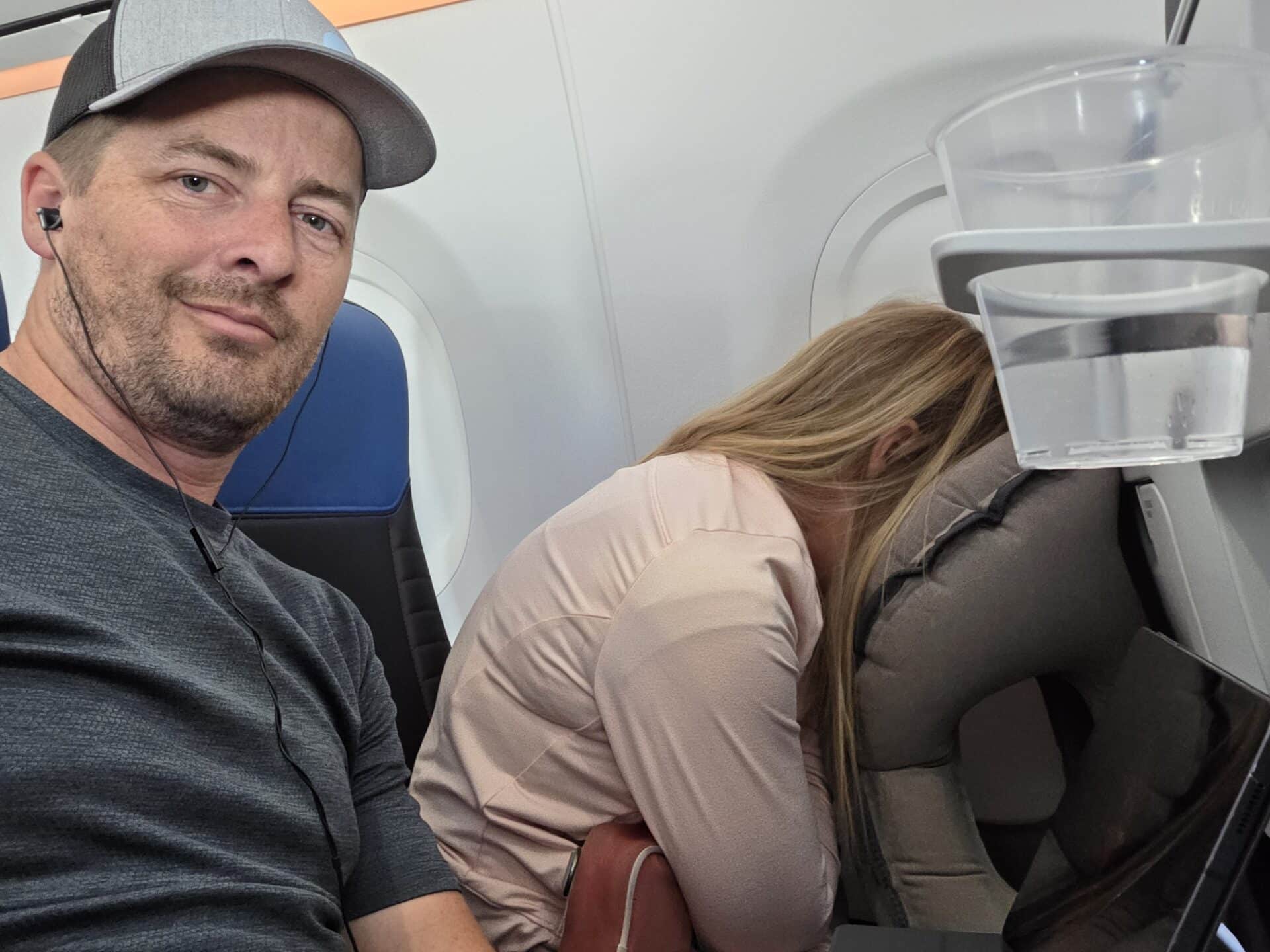 In this photo, David Butler and his wife showcase practical strategies for managing back pain during air travel.